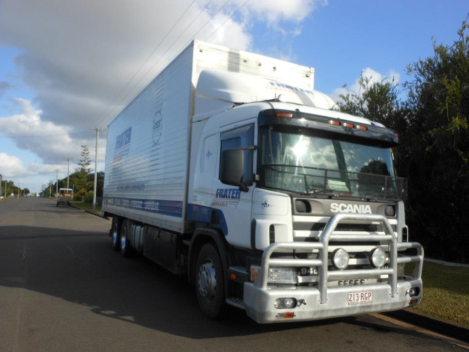 White Scania removals truck with a bull bar on a quiet road